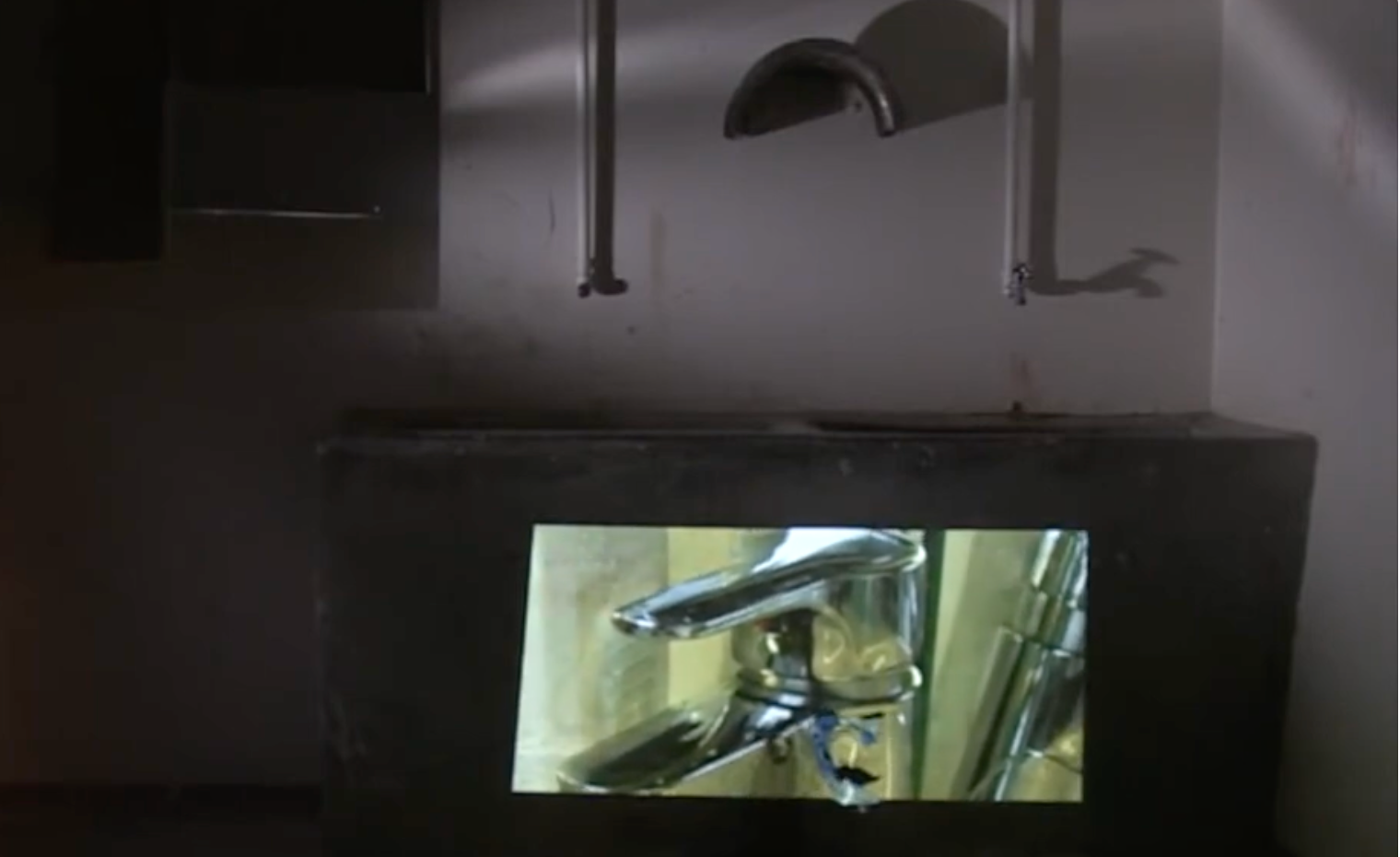 Still from the Water Psycho (Vattenpsyko) installation, showing a dripping tap projected in a darkened room. Photo: Zayera Khan.