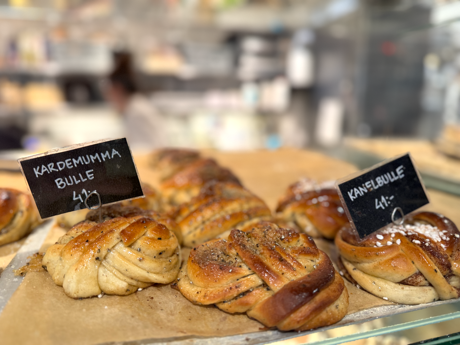Freshly baked Swedish cinnamon buns (kanelbullar) sprinkled with pearl sugar.