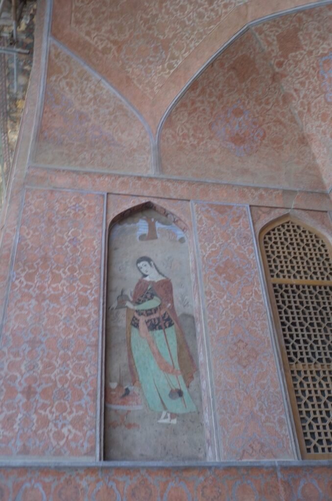 Wall painting of a woman in a green dress in Ali Qapu Palace