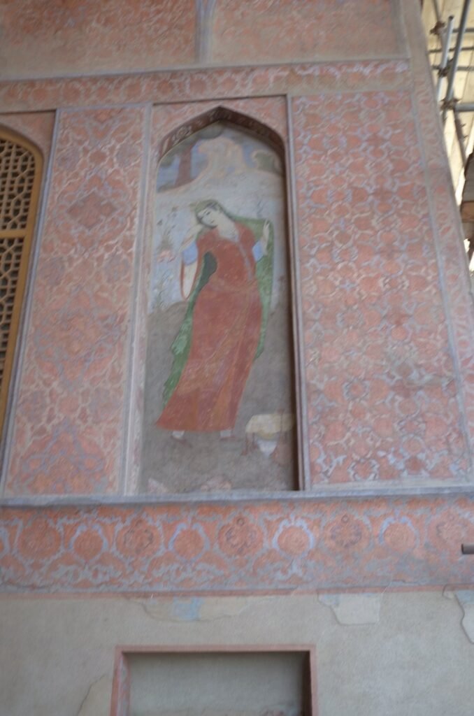 Wall painting of a woman in a red dress in Ali Qapu Palace