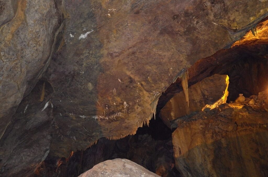 Large cave hall with yellow and brown rock in Ali Sadr Cave
