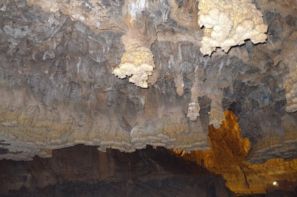 White rock formations above the water in Ali Sadr Cave