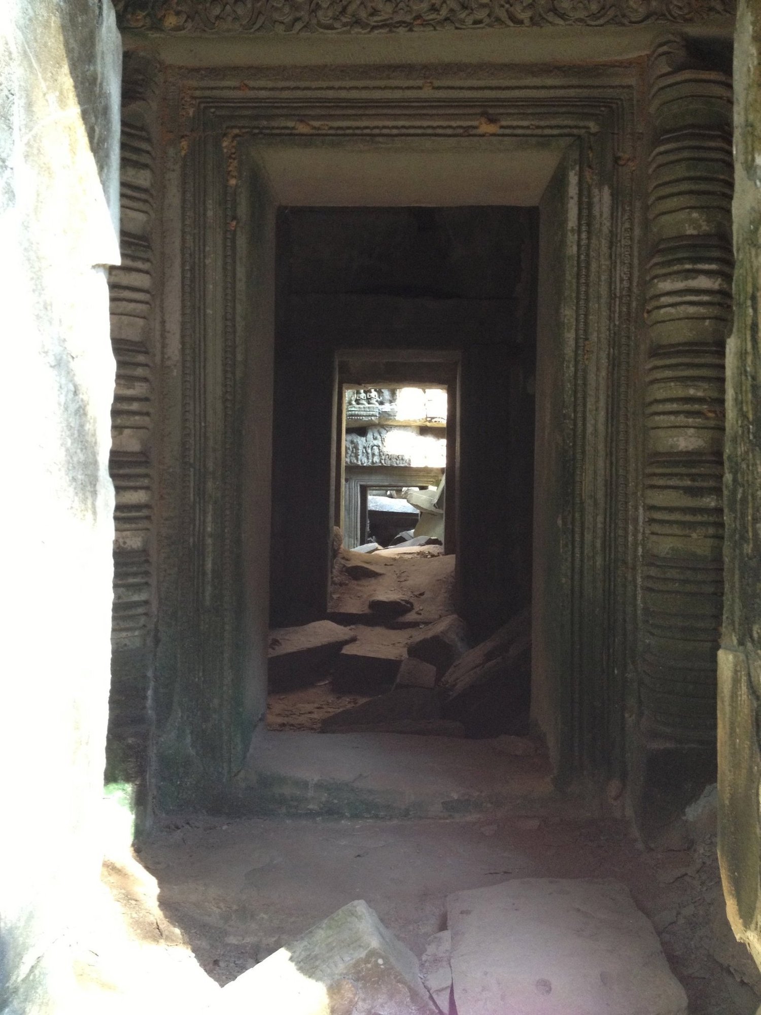 A row of stone doorways makes a long corridor inside a temple at Angkor.