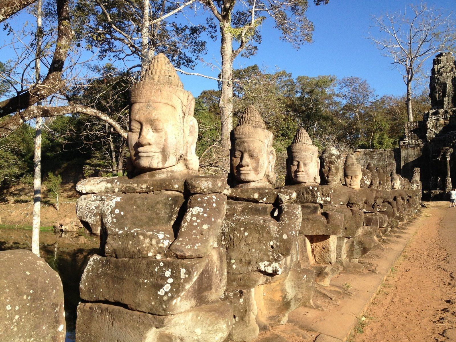 A row of stone guardian heads stands along the causeway at Angkor Thom in Cambodia.