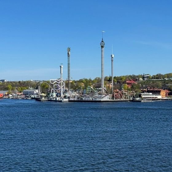 Boats moored in a small harbour lined with buildings in the Stockholm archipelago, photographed by Zayera Khan