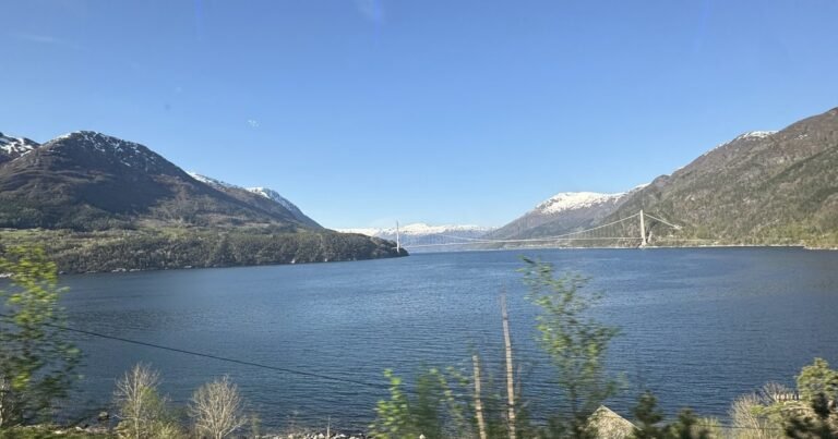 Hardangerfjord and the Hardanger Bridge between green slopes, Norway