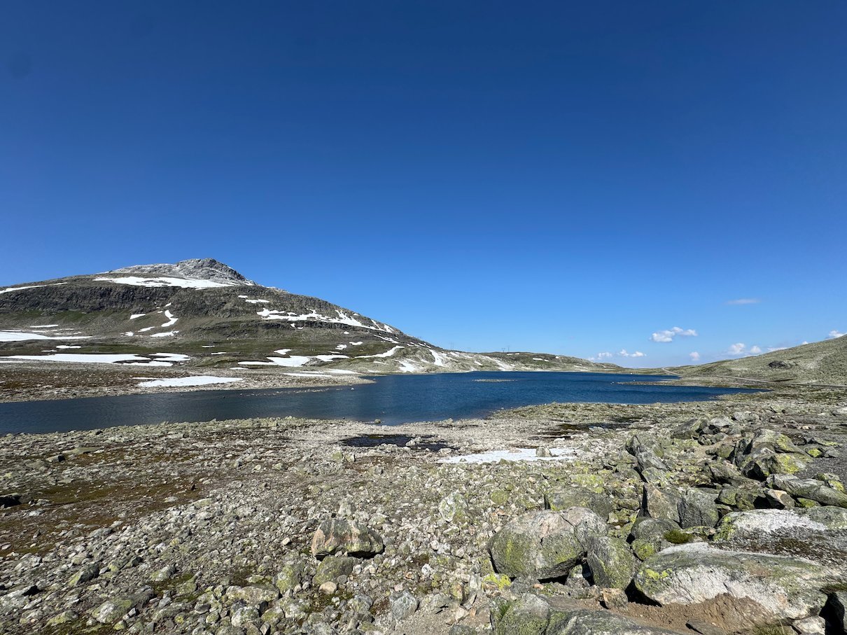 Mountain lake below a snowy summit on Aurlandsfjellet