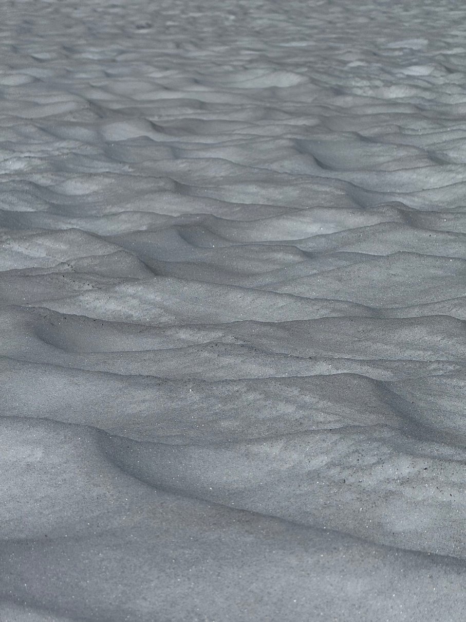 Close view of the uneven surface of old summer snow