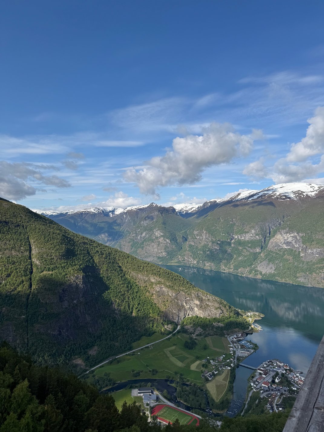 View down to the Aurlandsfjord and Aurland village from Stegastein, with snowy peaks