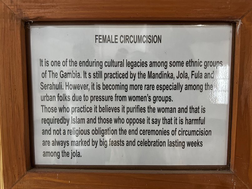 A framed text about an old custom among Gambian ethnic groups hangs in the Kachikally museum.