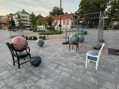 Les Sièges des Mondes by Alicja Kwade, chairs with stone spheres on a square in Borås