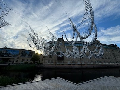 Light hanging sculpture like flying shapes over the Viskan river in Borås