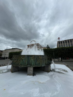 Fountain in a square in Borås under a grey sky