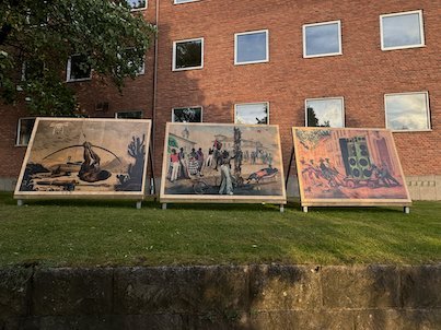 Three more painted panels by Gê Viana on a lawn in Borås