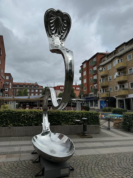 Giant steel spoon sculpture on a square in Borås