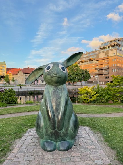 Green rabbit sculpture by the river in Borås