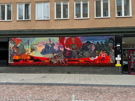Long colourful mural above a shop front in Borås