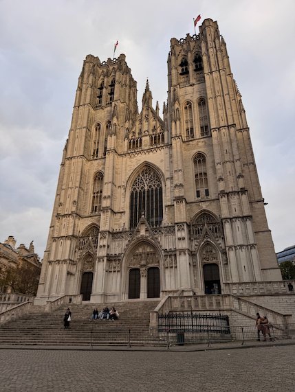 The two Gothic towers of the Cathedral of St. Michael and St. Gudula rise above wide steps.