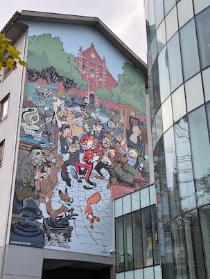 A large comic strip mural covers the side of a building in Brussels.