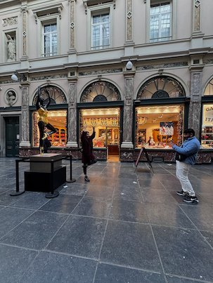 Visitors take pictures of a sculpture in the Galeries Royales Saint-Hubert in Brussels.