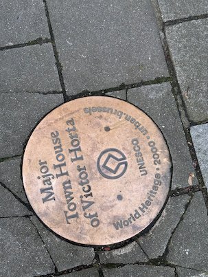 A bronze marker in the pavement points to the Town House of Victor Horta in Brussels.