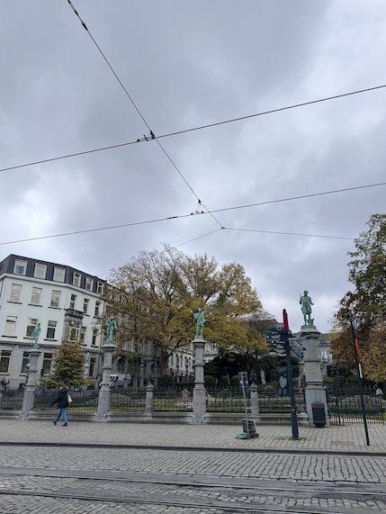 Small statues stand on the fence of the Petit Sablon garden in Brussels.