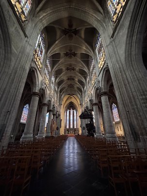 The tall Gothic nave of the Sablon church leads to the choir in Brussels.