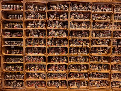 Wooden shelves are full of small figurines in a shop in Brussels.