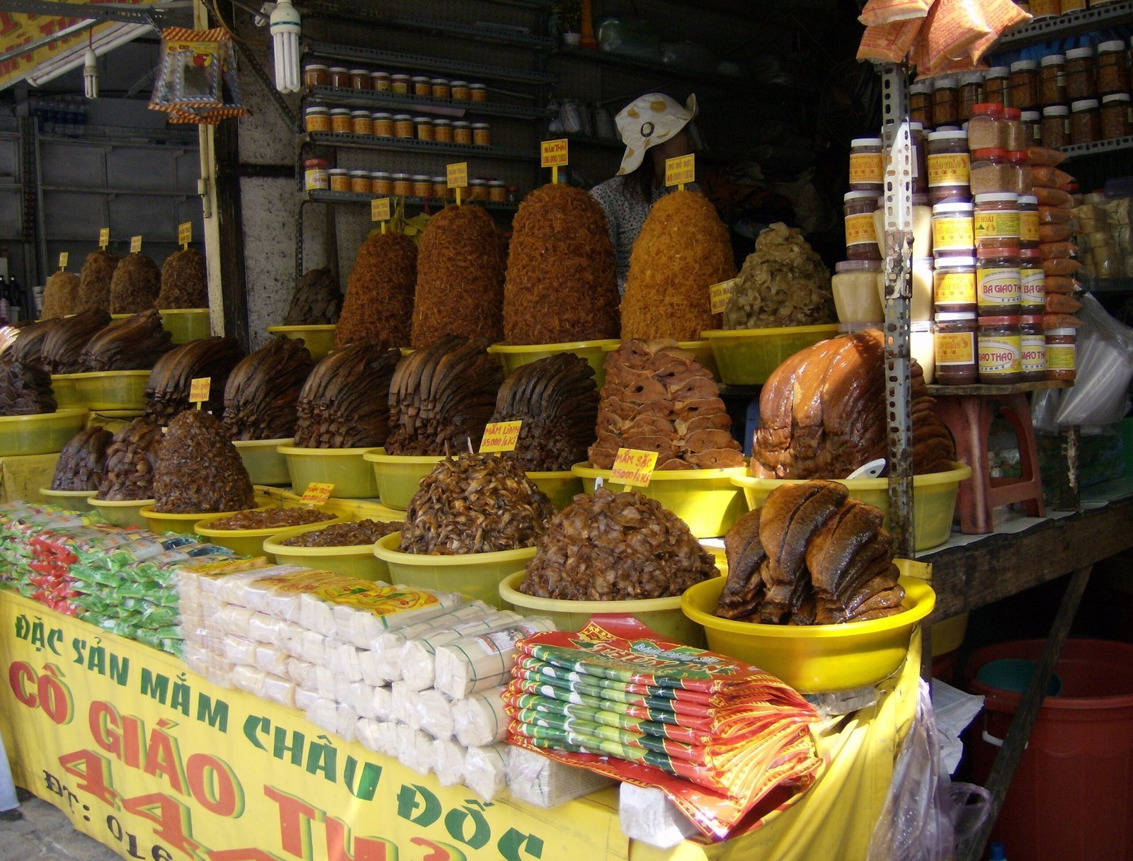 A market stall sells fermented fish and jars of food in Chau Doc, Vietnam.