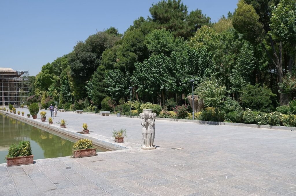 Long pool with stone statues and trees at Chehel Sotoun
