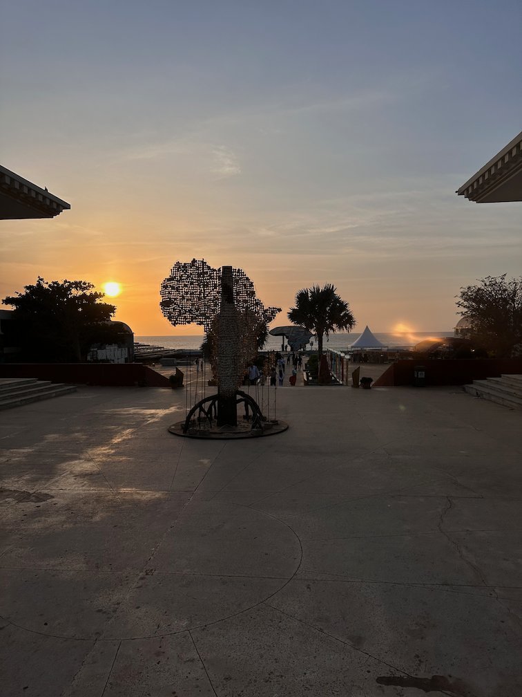 A path leads to the Africa sculpture at dusk in Dakar.