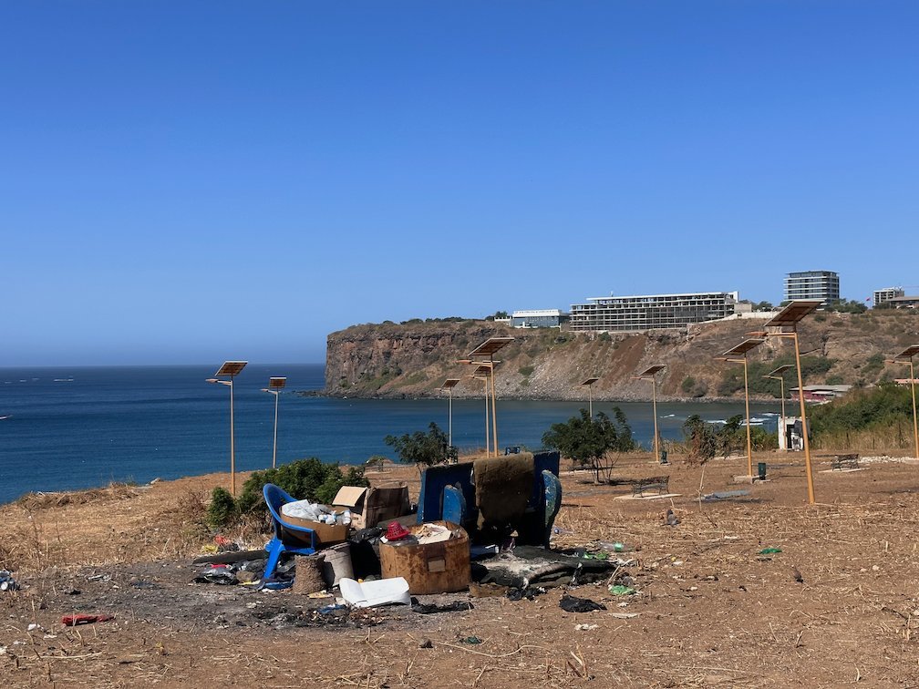 Litter lies on a hill above the sea and a cliff in Dakar.