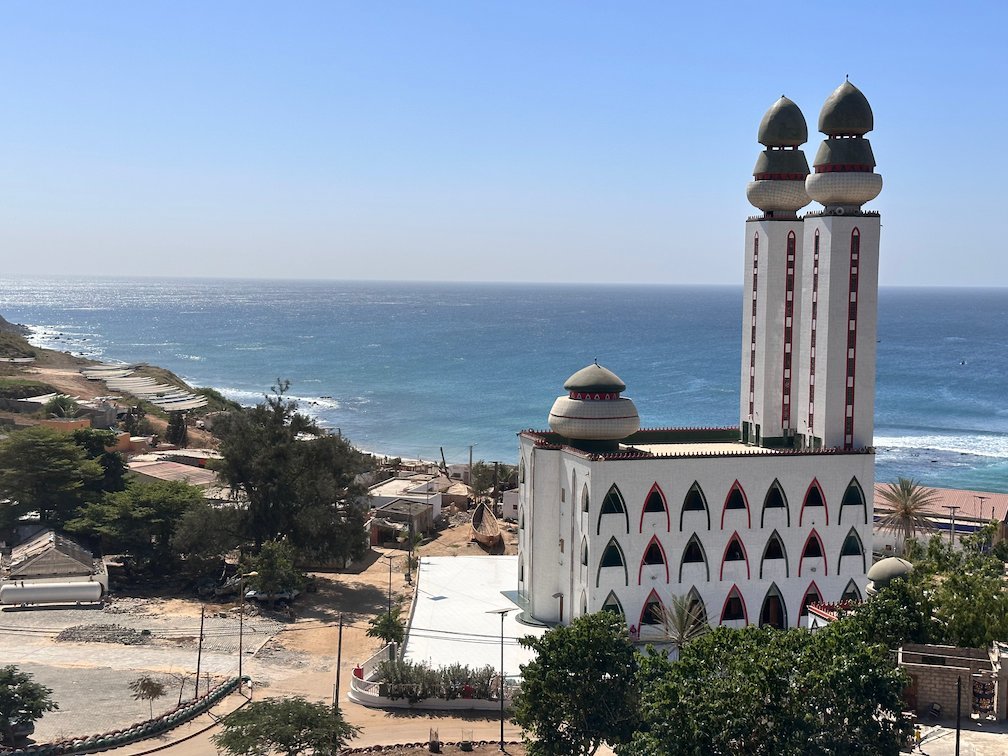 The two minarets of the Mosque of the Divinity rise above the coast in Dakar.