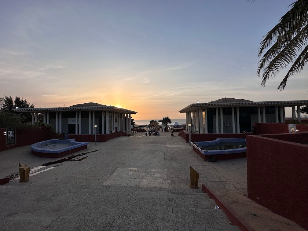 The sun sets behind empty buildings at an old hotel site in Dakar.