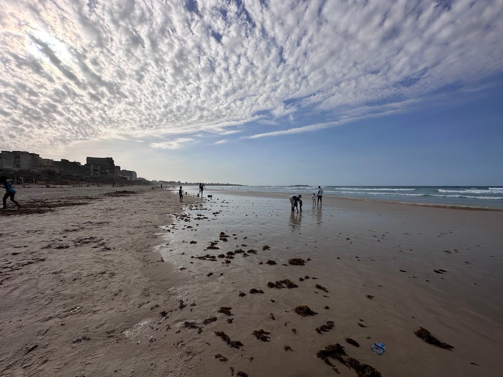 Low tide and white clouds over Yoff beach in Dakar.