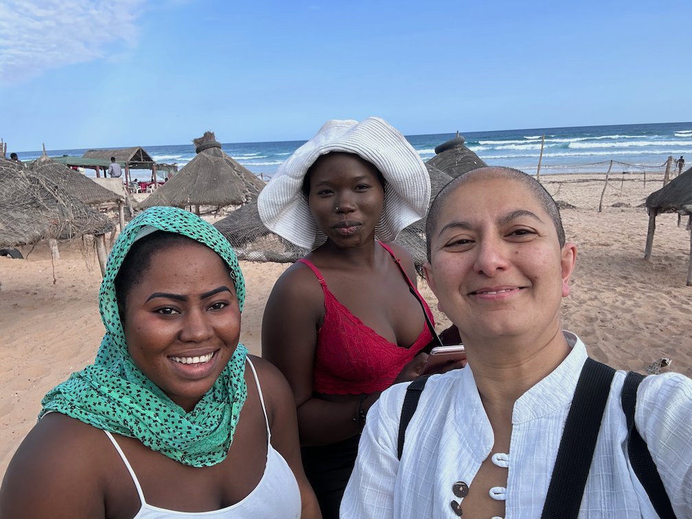 Zayera Khan takes a selfie with two women on Yoff beach in Dakar.