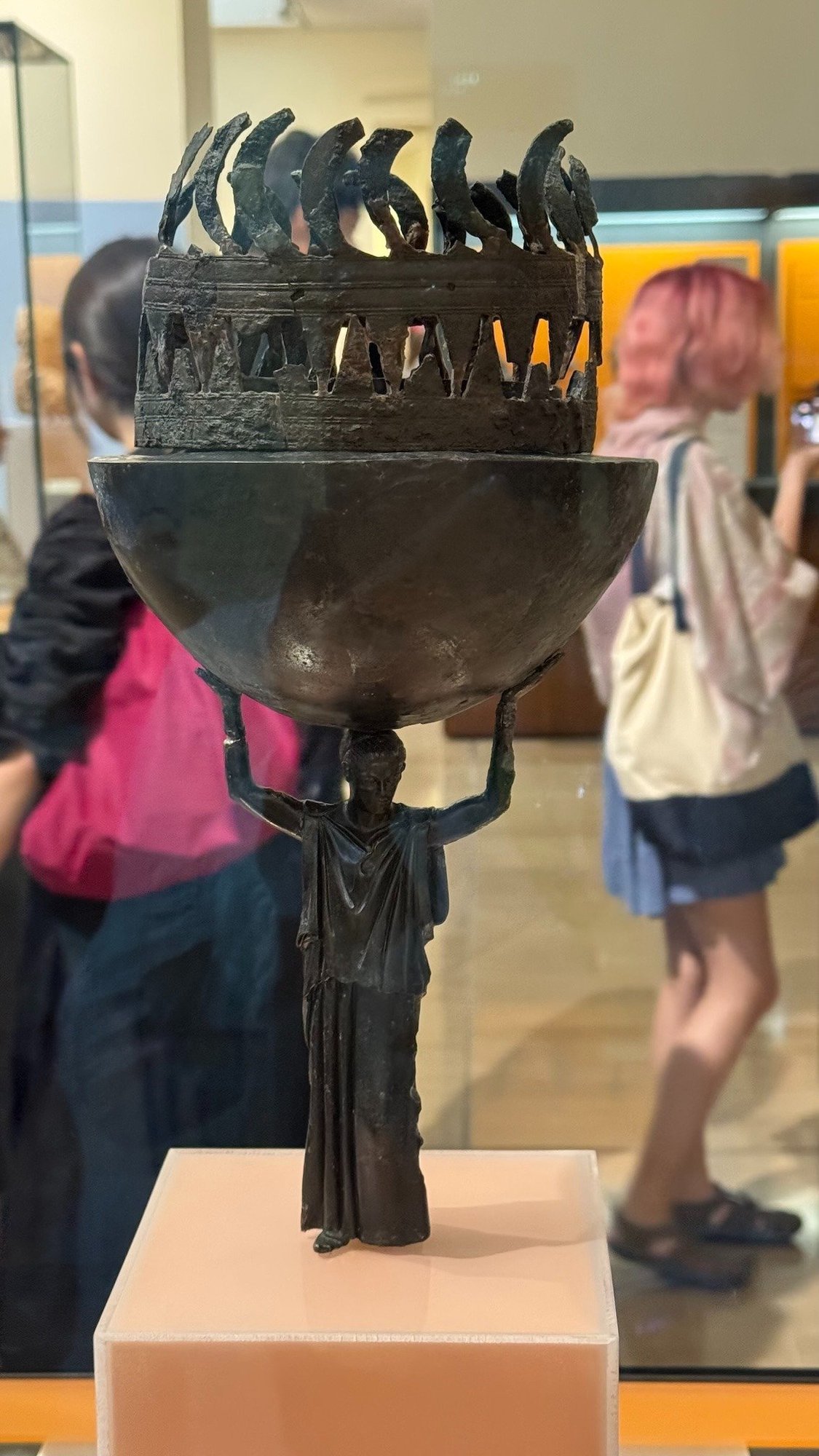 Bronze incense burner held up by a small female figure in the Delphi Archaeological Museum