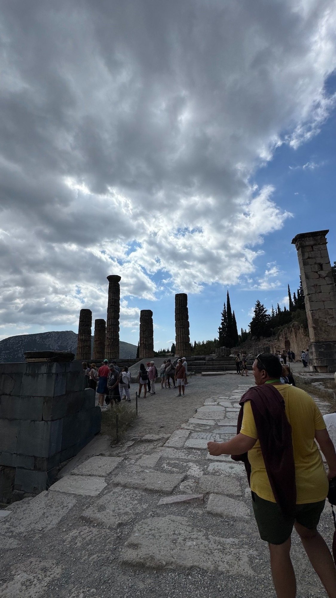Visitors walk on the Sacred Way toward the Temple of Apollo at Delphi