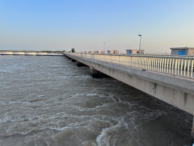 Water flows fast below the long Diama dam on the Senegal River at the border.