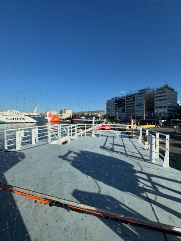Open ferry deck with the buildings of Piraeus port behind