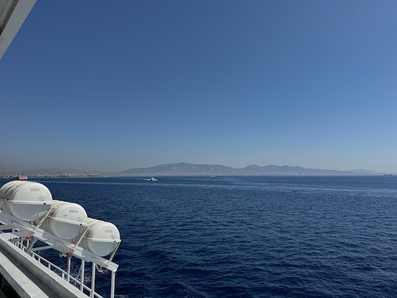 Lifeboats on the ferry and the open Saronic Gulf with mountains far away