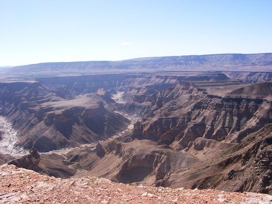 Layers of brown rock and deep gorges spread to the horizon at Fish River Canyon, Namibia.