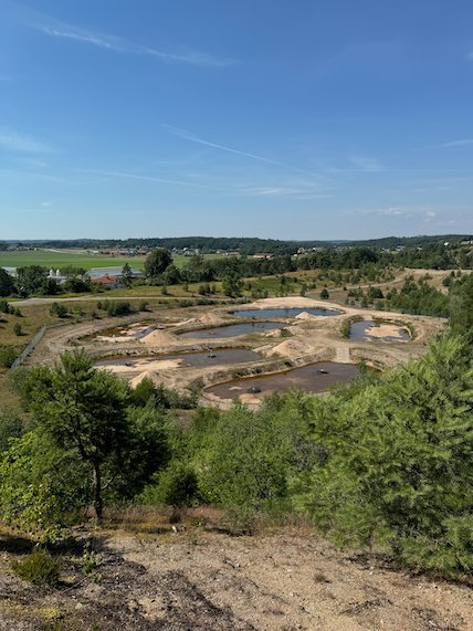 Old gravel pit with small ponds below the Fjärås Bräcka ridge, seen from above