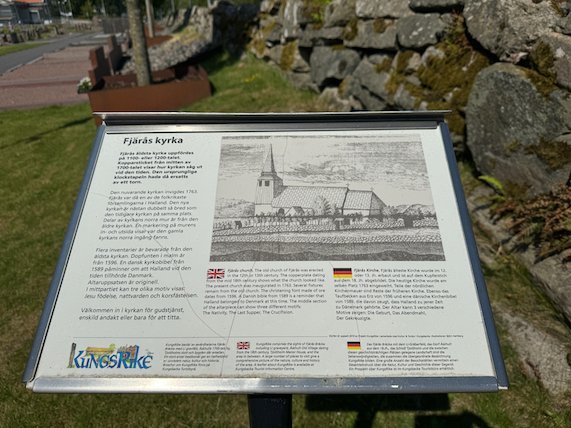 Information sign about Fjärås church with an old drawing of the church, in front of a stone wall