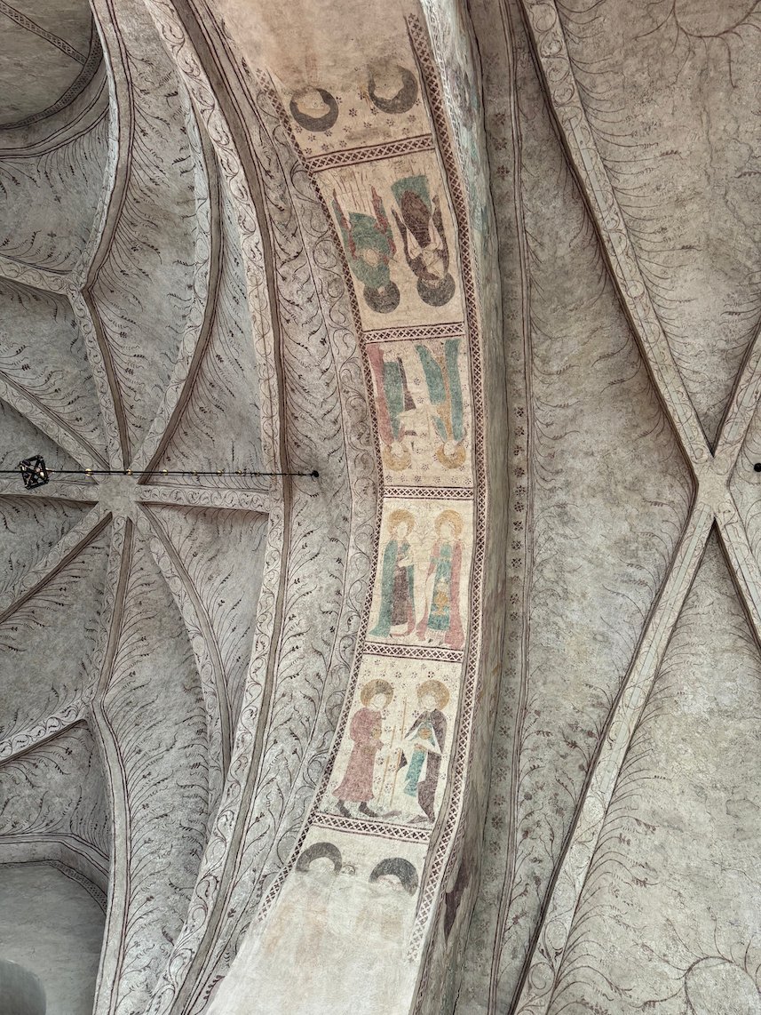 Vault ribs painted with medieval figures of saints inside Gamla Uppsala church