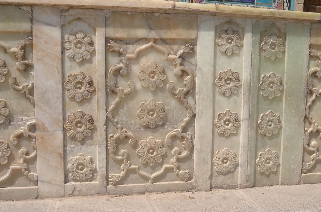Marble wall with carved flowers at Golestan Palace
