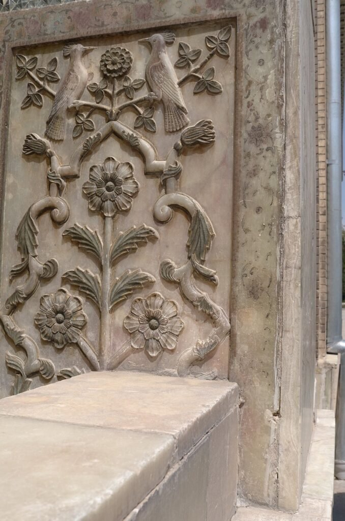 Carved stone panel with birds and flowers at Golestan Palace