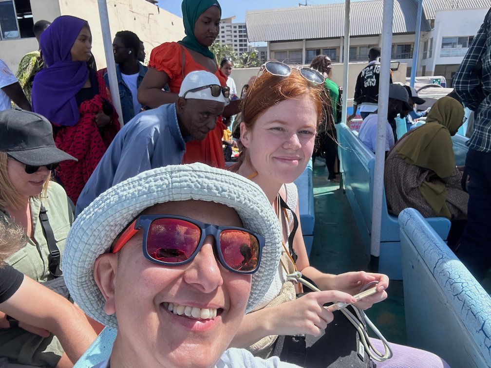 Zayera Khan takes a selfie with passengers on the ferry to Goree Island.