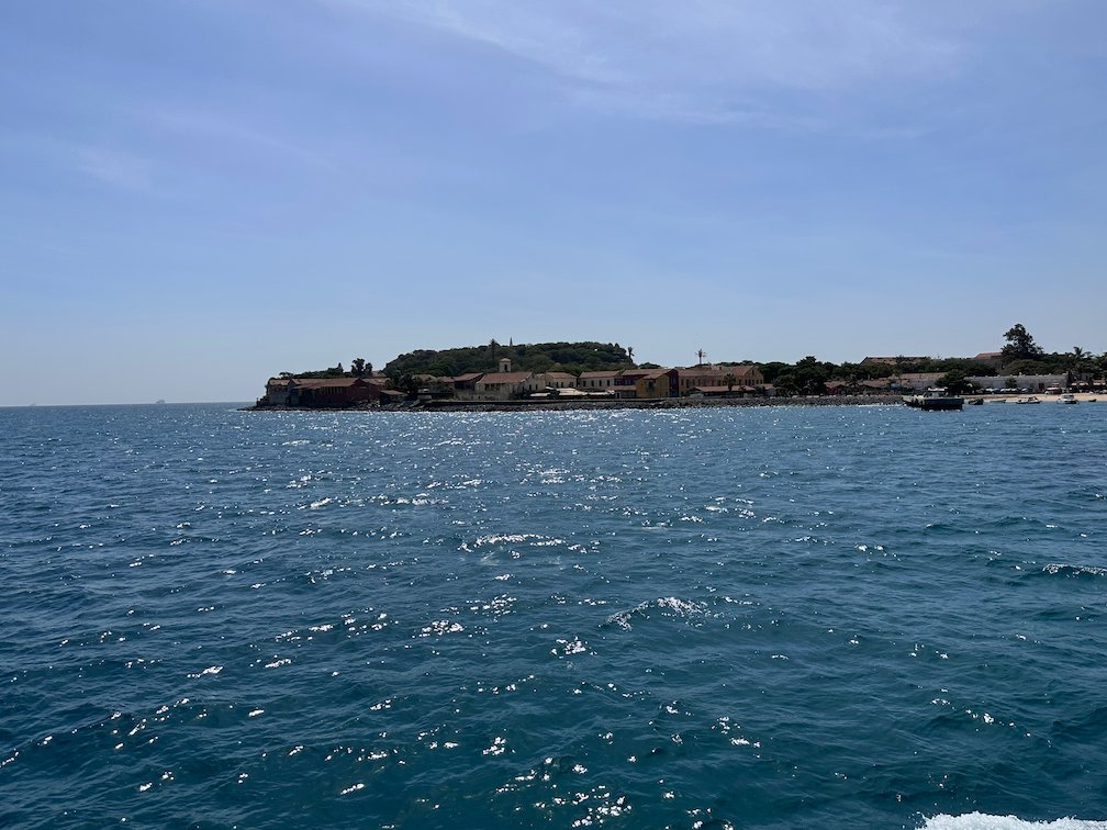 Goree Island lies low on the sea, seen from the ferry.