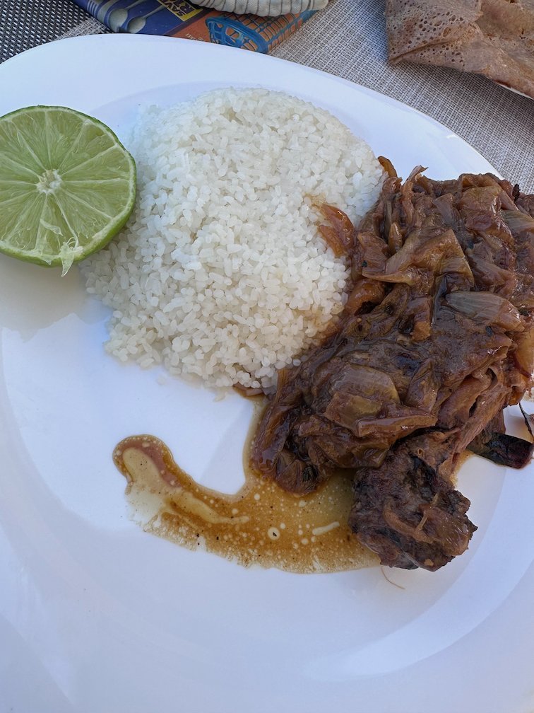 A plate of yassa with onions, rice and lime on Goree Island.